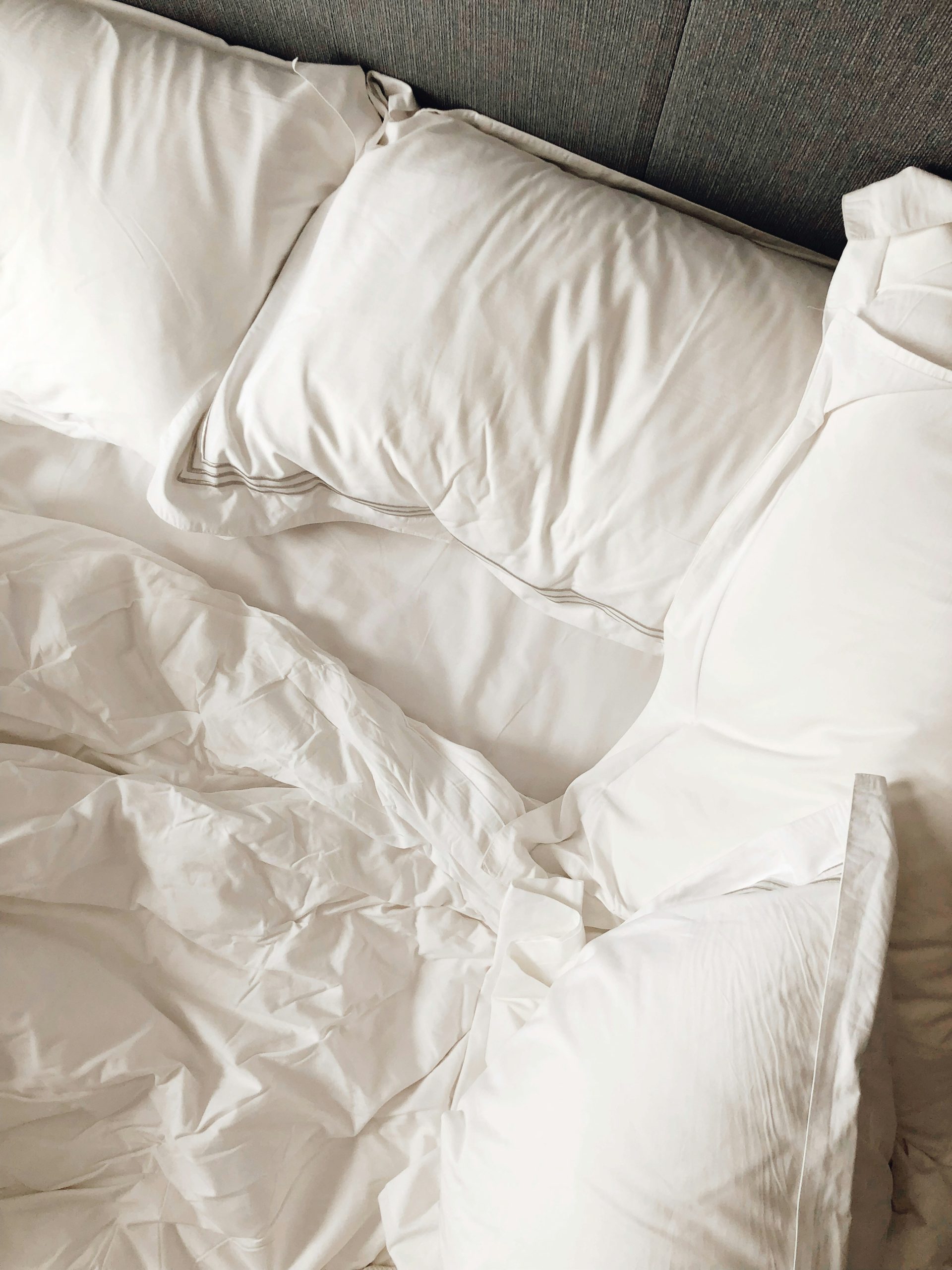 a white pillow on a bed